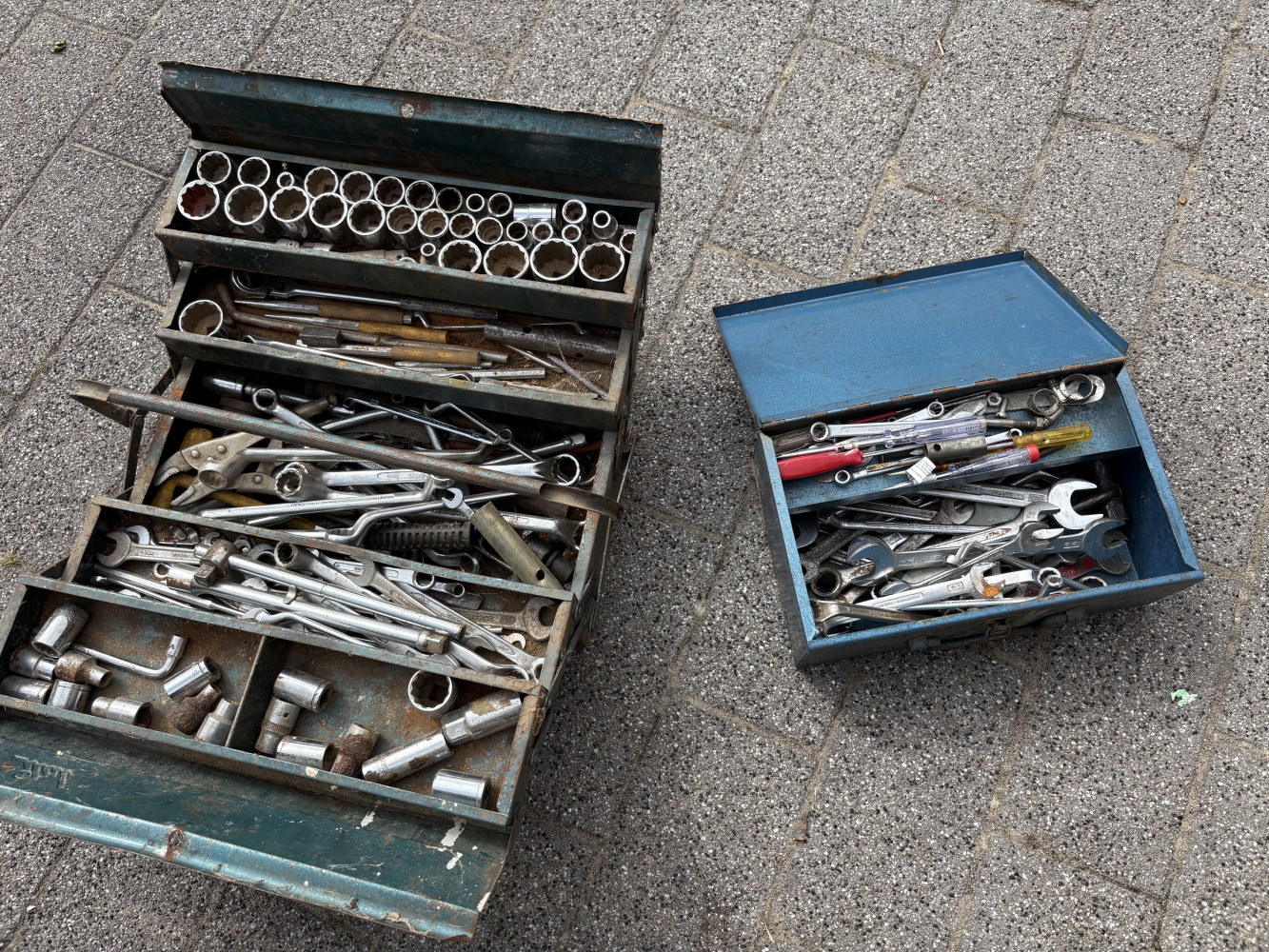 Large cantilever mechanics tool box filled with sockets and spanner’s and smaller metal one loaded with spanner’s and other tools