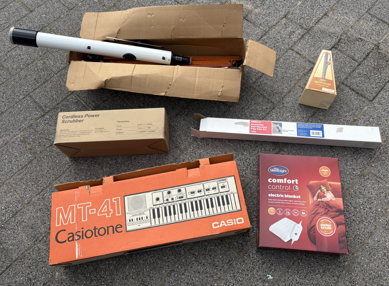 Boxed telescope, flag pole, keyboard, metronome and brush