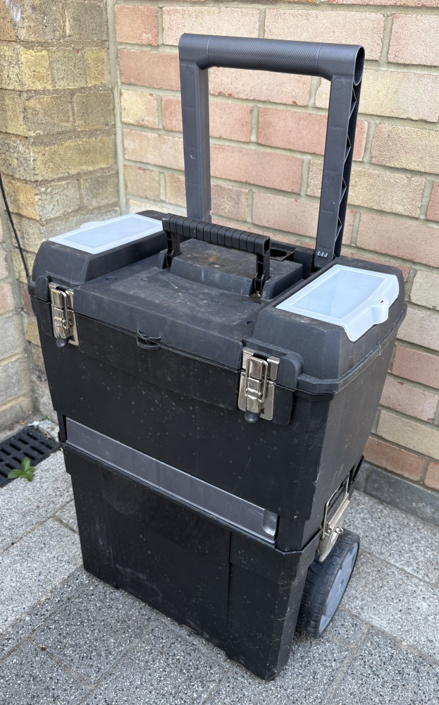 Stacking tool box loaded with tools, battery charger, jump leads, spanners and loads of other mixed tools