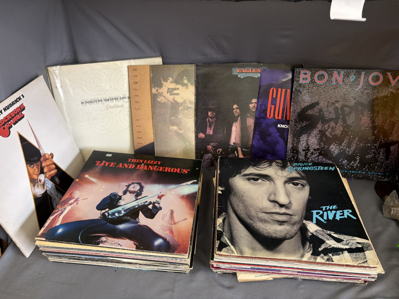 Collection of classic vinyl records featuring iconic albums like Bruce Springsteen's The River and Thin Lizzy's Live and Dangerous