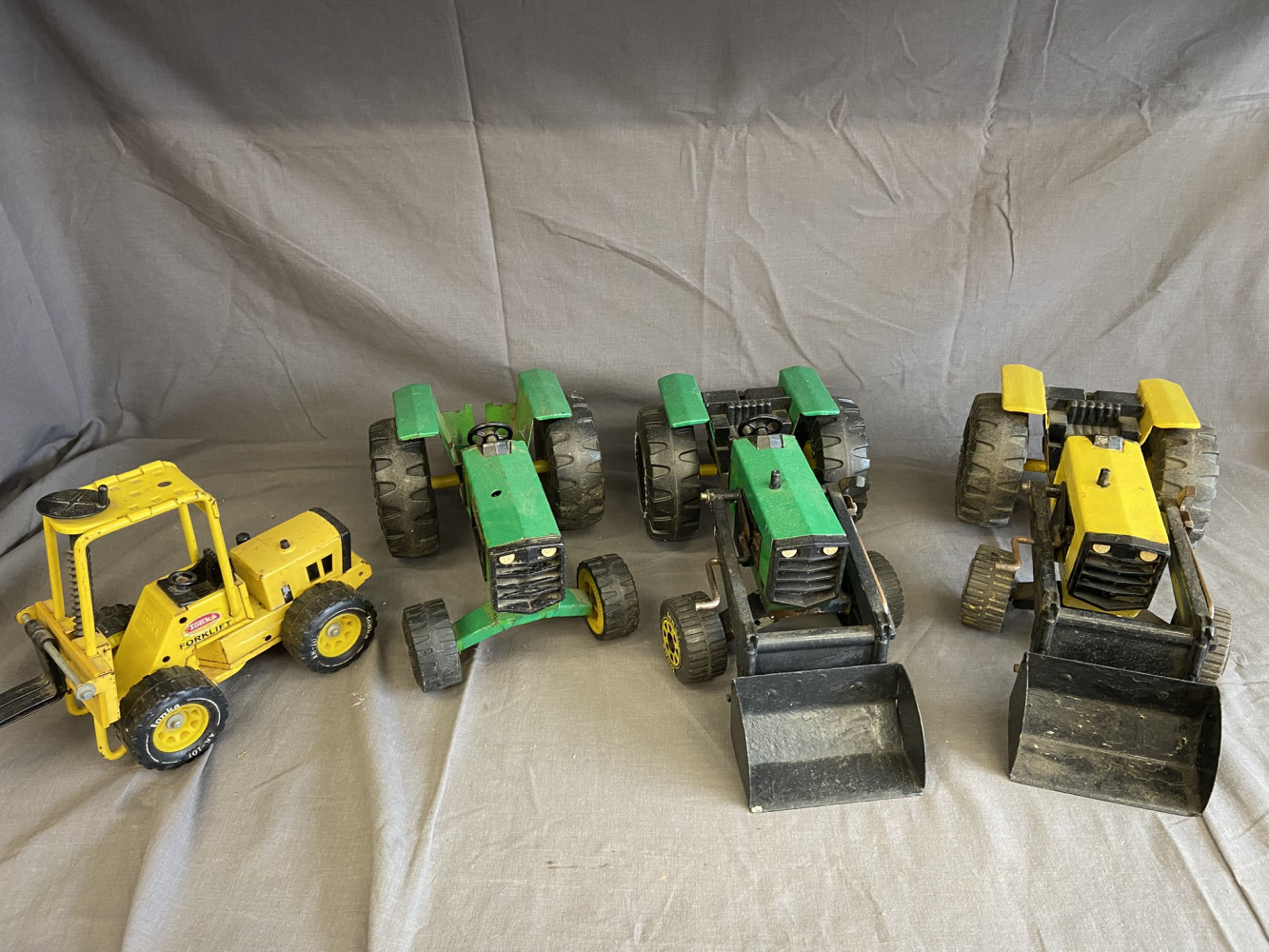 4 Metal Toys some Tonker. Three Tractors and Fork lift