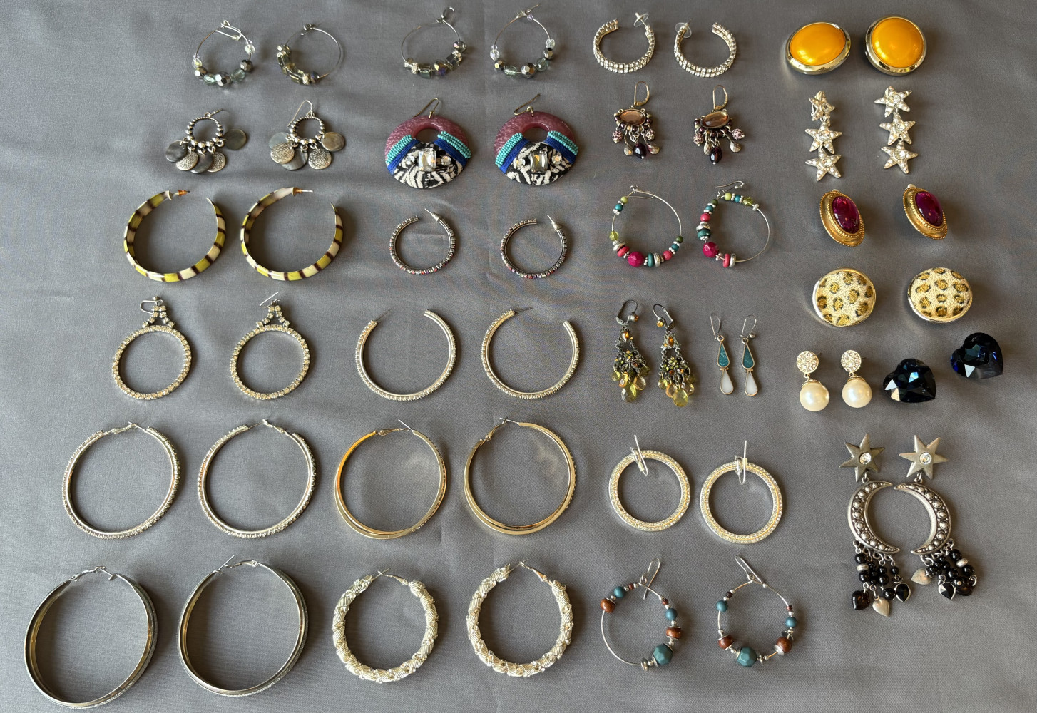 26 pairs of earrings some normal some are clip ons
