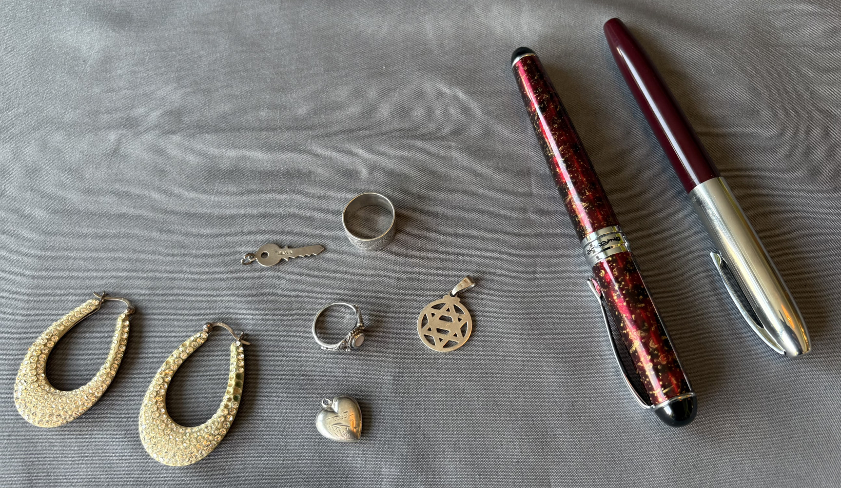 Sliver rings, pedants and earrings clasps and two pens one a Jinhao fountain pen with gold plated nib which is slightly bent