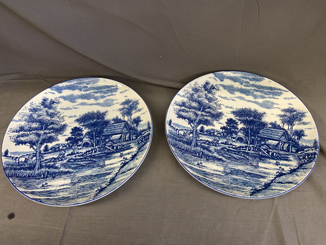 2 vintage blue and white ceramic chargers