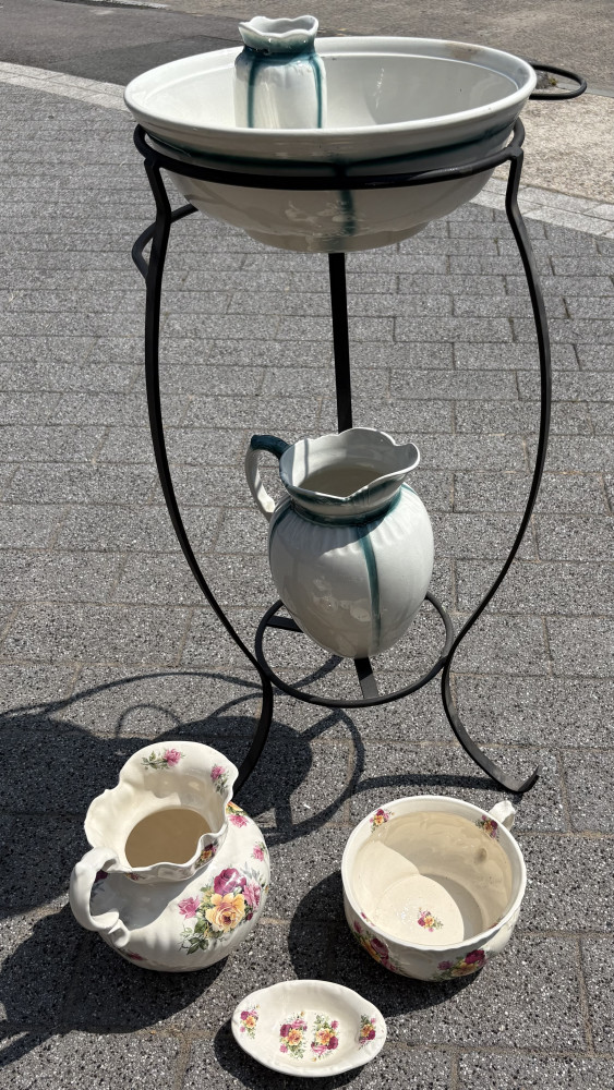 Vintage-style ceramic toilette set on a black wrought iron stand And spare jug, pan and side bowl
