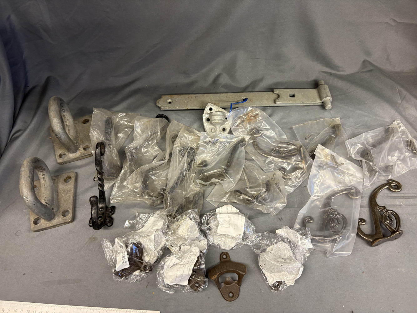 Job lot of new ironwork, 7 bottle openers, 11 new coat hooks and other items