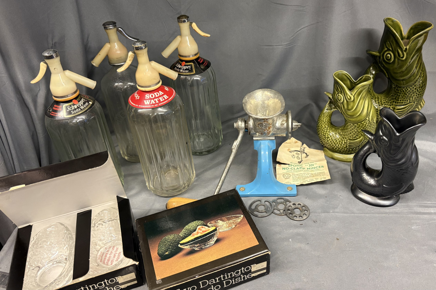4 Vintage Schweppes soda syphons, 3 fish glug jugs, 2 new boxed glass dishes and mincer
