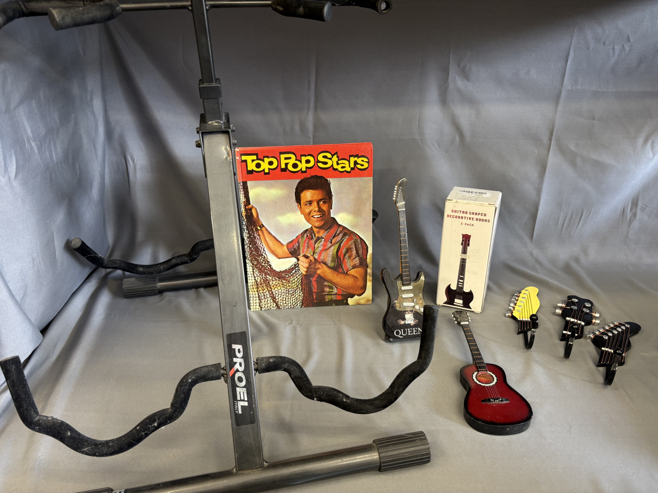 Double guitar stand, guitar shaped hooks, book and miniature guitars