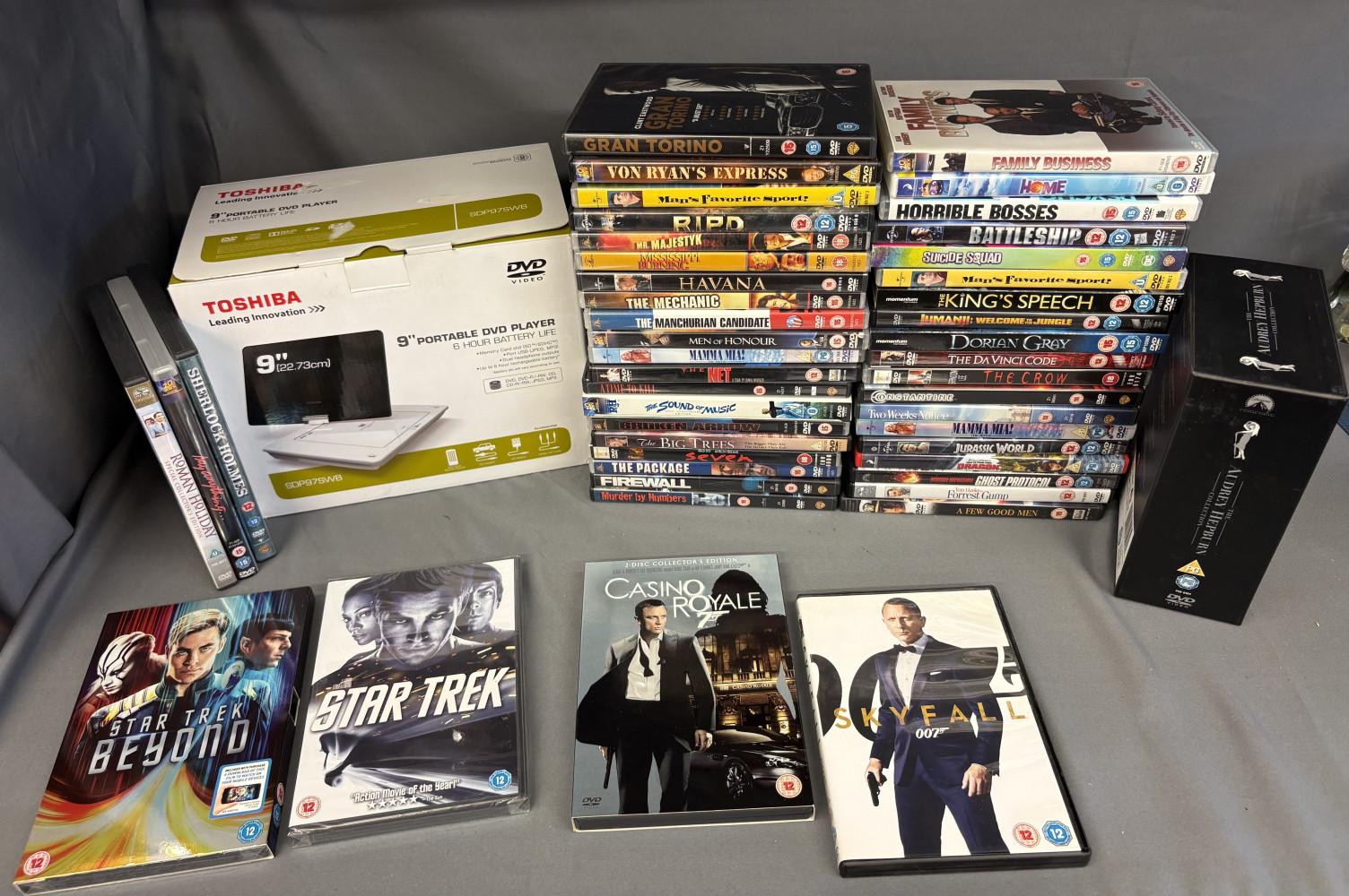 Unused portable DVD player with large lot of DVDs