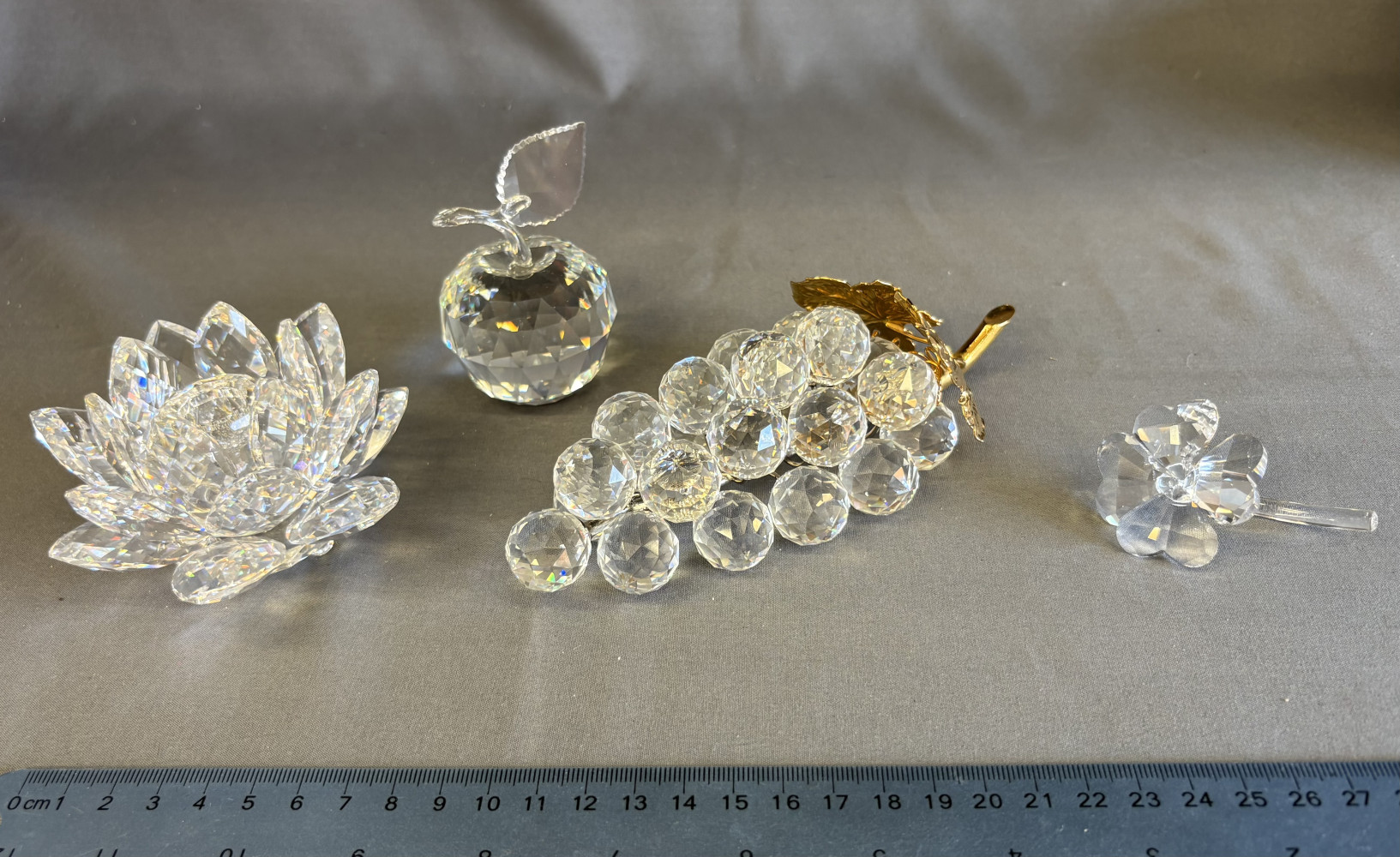 Swarovski Crystal Bunch of Grapes 011864, Swarovski Crystal Clear Water Lily Candle Holder No 119747, Swarovski crystal four leaf clover 212101 and Swarovski Silver Crystal "Sparkling Fruit" large apple figurine no 160796