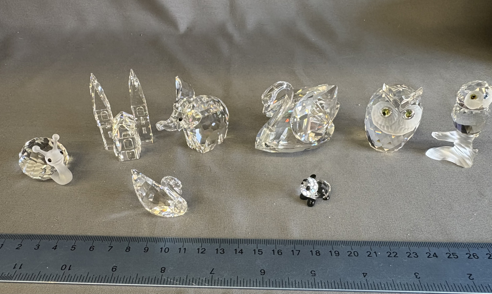 Swarovski Crystal Snail no 012725, retired Swarovski Crystal City Cathedral no 157858, vintage Swarovski Silver Crystal Elephant, Swarovski 10006 Swan Crystal Figurine and small swan, Swarovski Crystal Owl on Branch no 119442, medium Owl and others