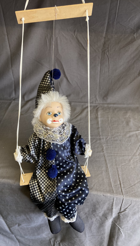 Clown hanging on a swing