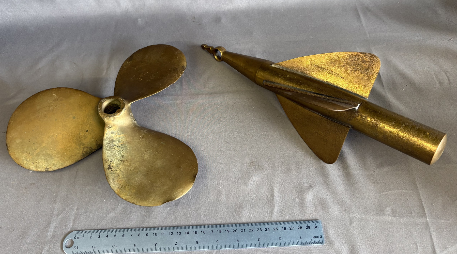 A Cherub Taffrail Log Spinner and a brass propeller