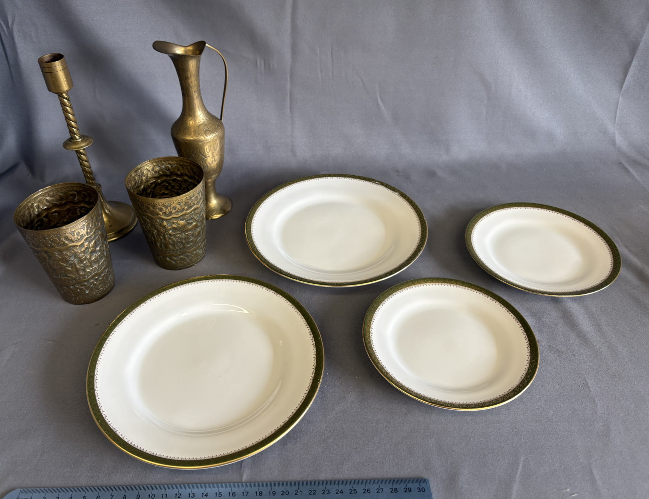 Four Wedgwood plates and brass beakers, jug and candlestick