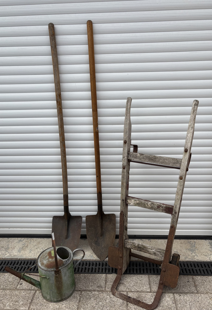 Two long handle spades, watering can and ornamental garden sack barrow