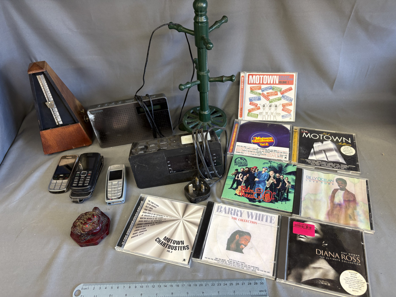 Mixed household lot including radios, metal mug tree, CDs, metronome, frog and phones