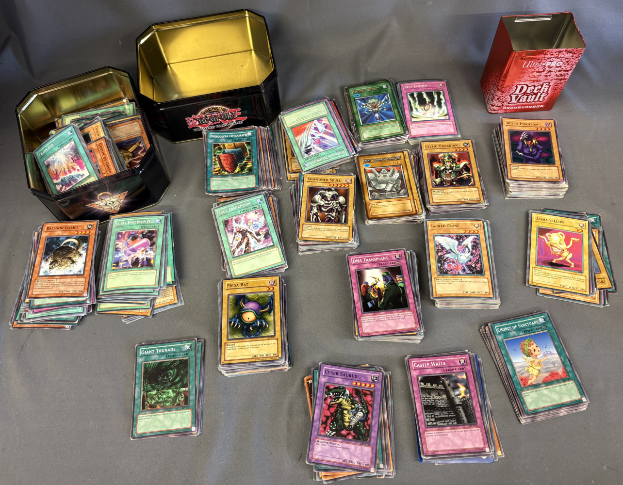 Large bundle of Yu-Gi-Oh trading cards and tins
