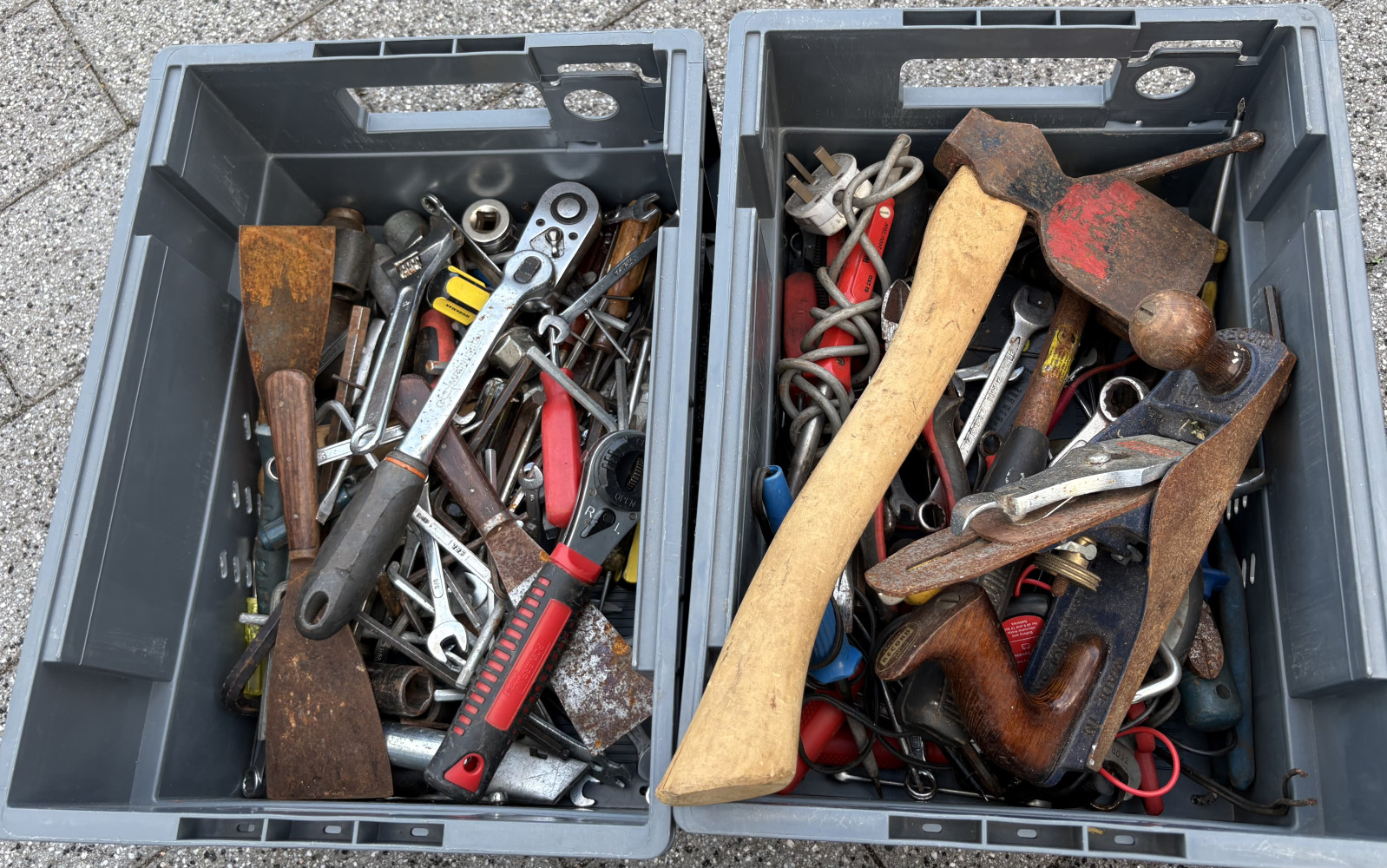 Two crates loaded with small tools, ratchets, spanners, axe, etc etc