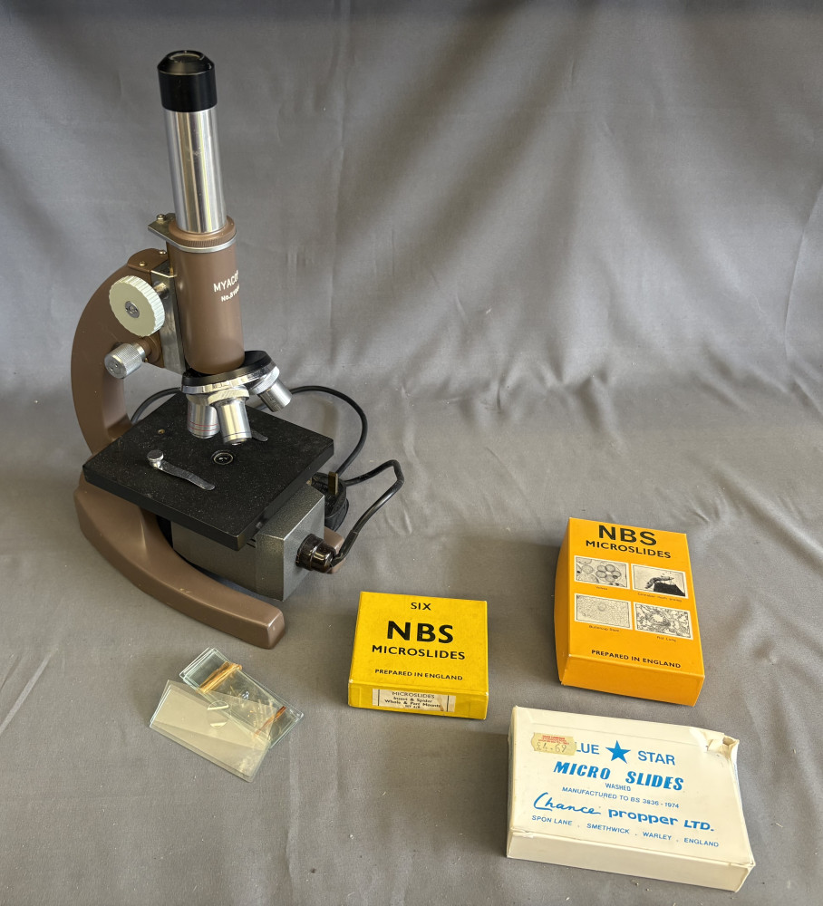 Vintage brown microscope with accessories