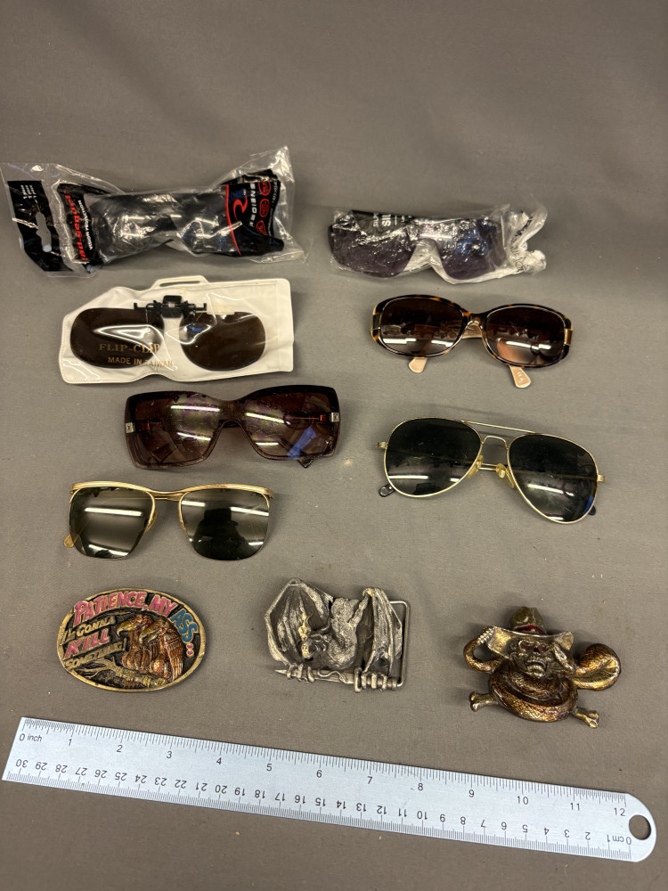 Three belt buckles and 7 pairs of sun glasses