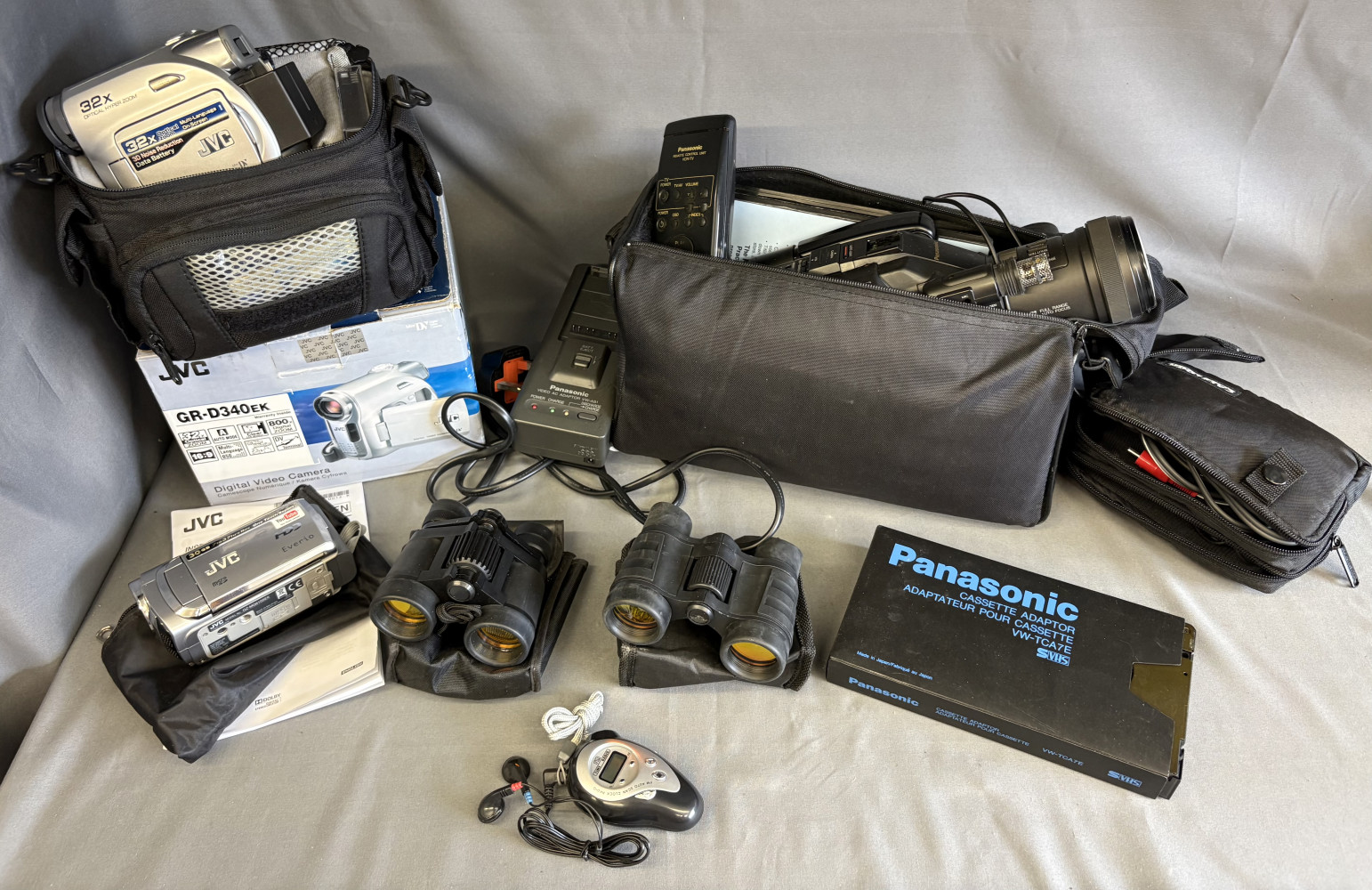 3 video cameras two new modern ones and one older one with playing cassettes, MP3 player and binoculars