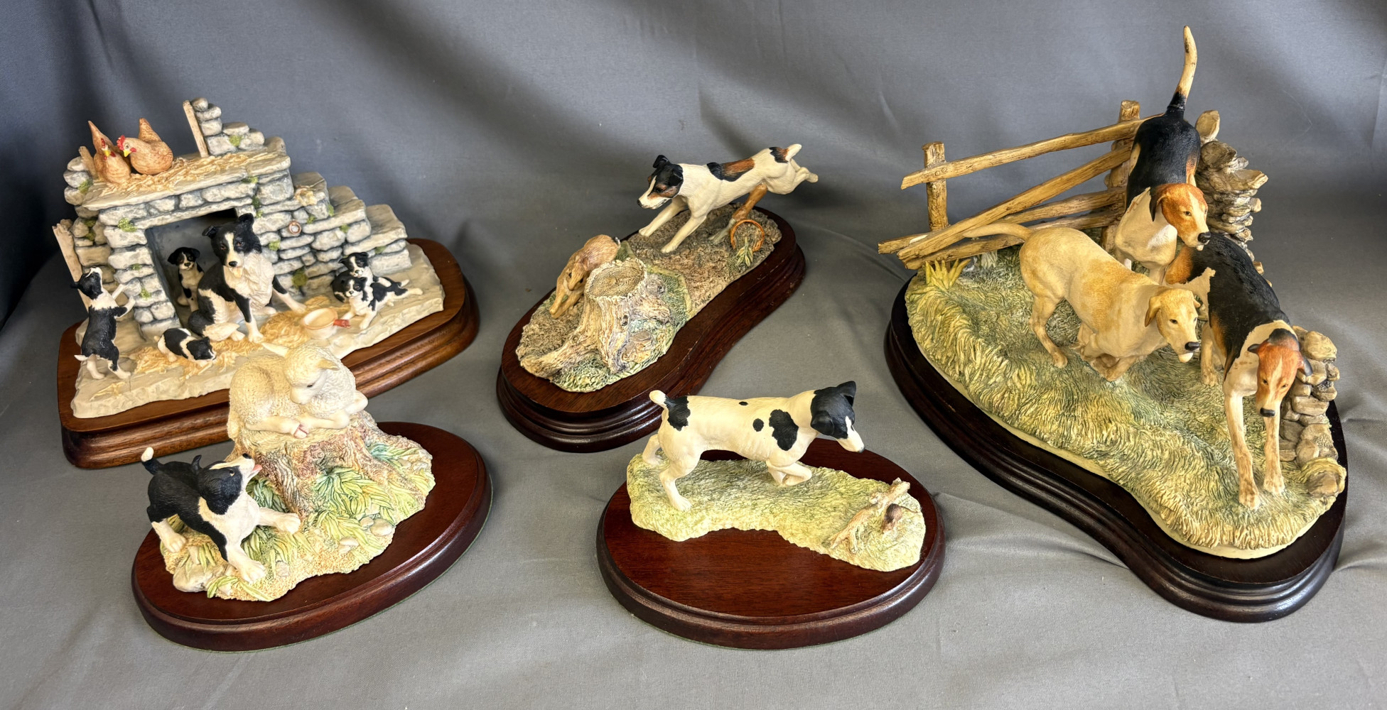 Collection of handcrafted Border Fine Arts figurines featuring Border Collies and farm scenes mounted on wooden plinths On my way one of the dogs tails has been glued