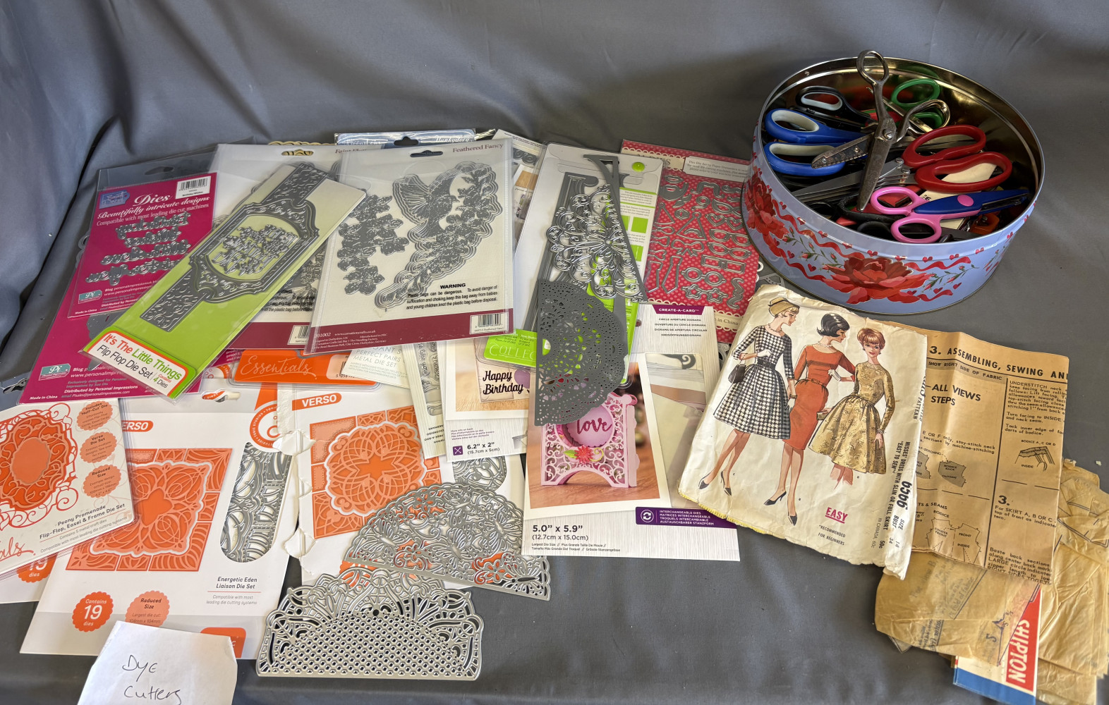 Large collection of crafting metal cutting dies, tub of crafting and other scissors and dress patterns