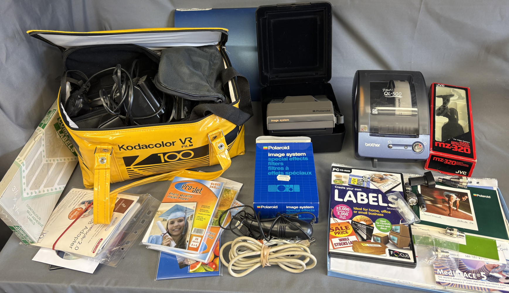 Vintage Kodac bag, label maker, vintage Polaroid camera and accessories