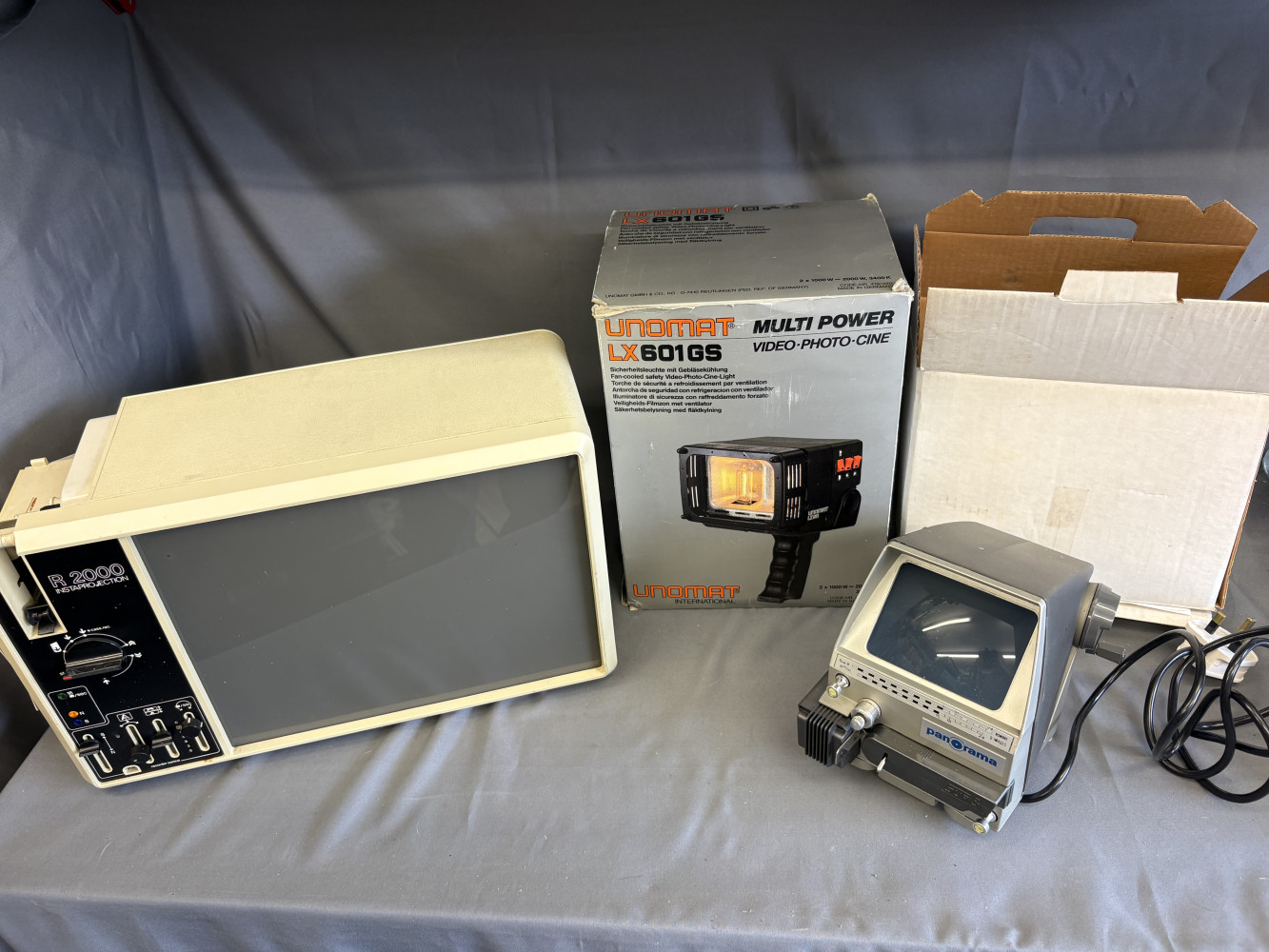 Vintage Eumig R 2000 Instaprojection Super 8 and 8mm film projector featuring a built-in daylight viewing screen, vintage Panorama 8mm cine film viewer and a vintage Unomat Multi Power LX601GS Video-Photo-Cine Light