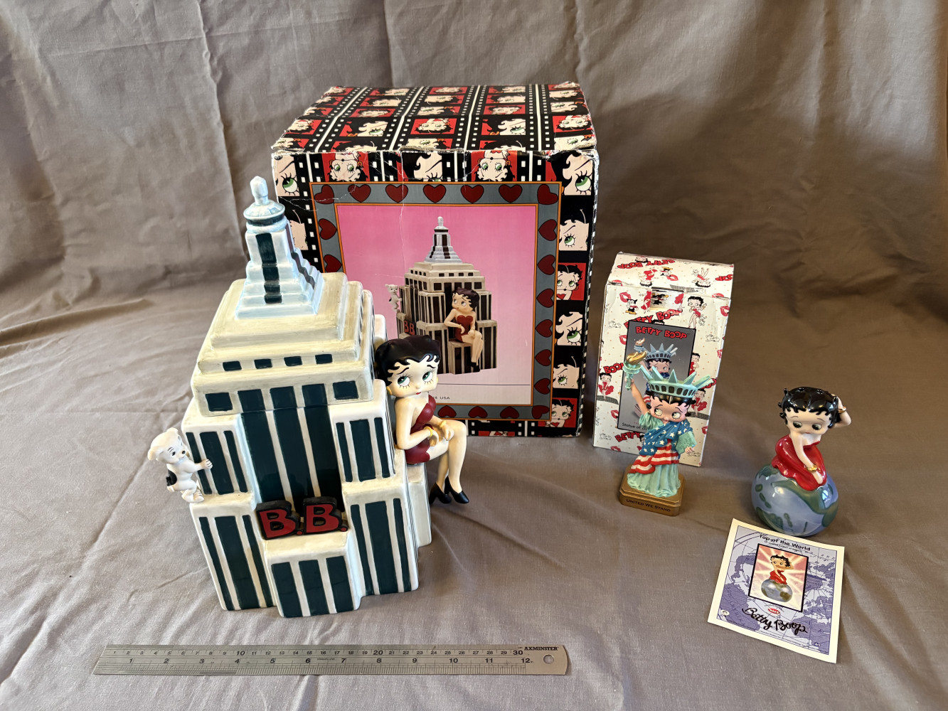 90s Betty Boop Empire State Building ceramic cookie jar featuring Pudgy the puppy, collectible Betty Boop Statue of Liberty figurine from the "United We Stand" series and a Top of the World limited edition figurine