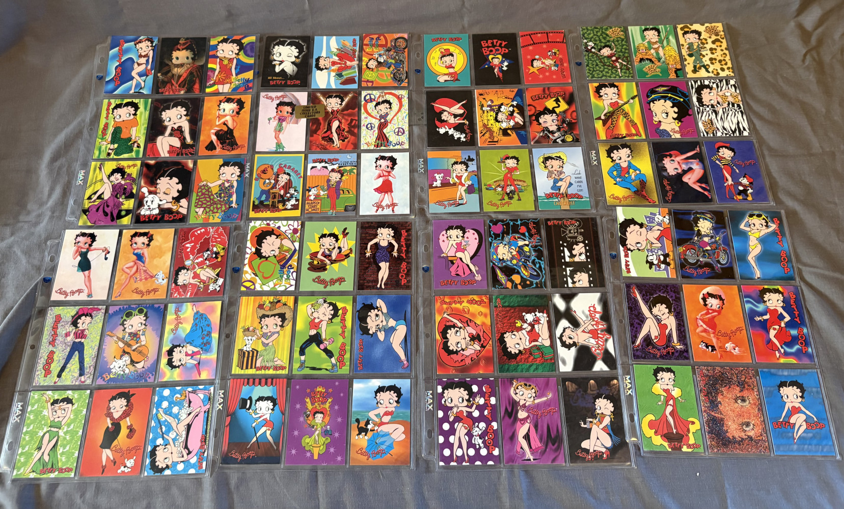 Collection of vintage Betty Boop trading cards organized in plastic binder sheets