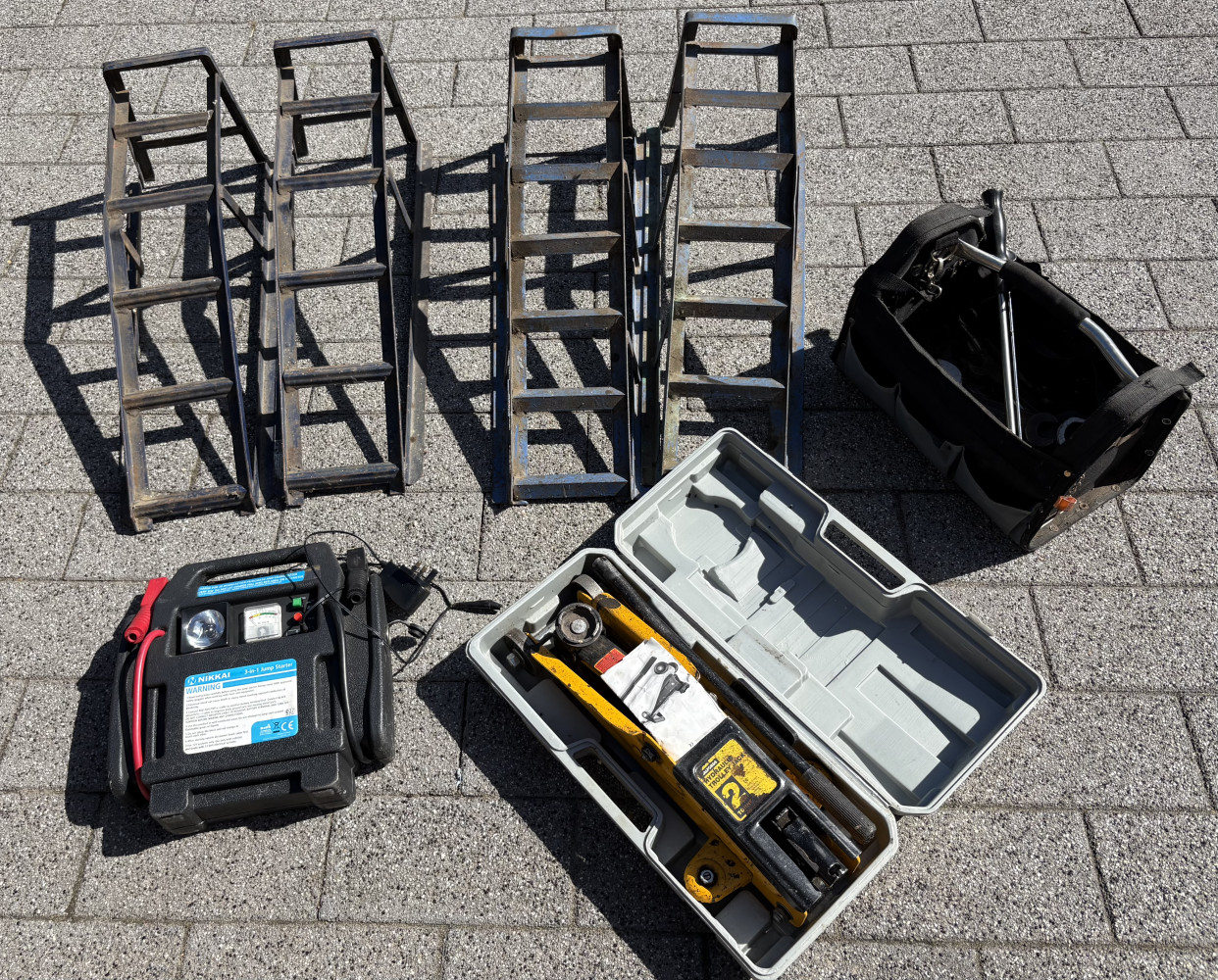 2 set of car ramps, trolley Jack, jump pack and bag of garage tools spanners wrench etc