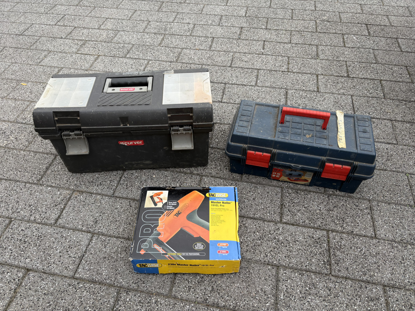 Tool box with plumbing tools and fittings, one with rivet gun and rivets and staple gun