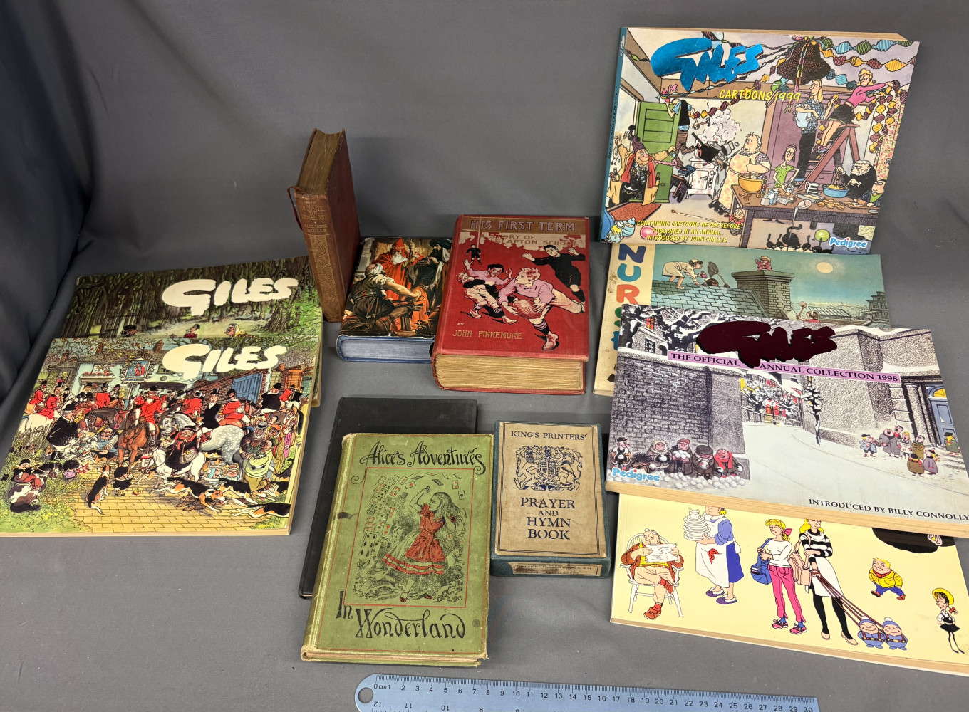 Antique copy of Lewis Carroll's Alice’s Adventures in Wonderland, Giles Cartoon Annuals and other literature