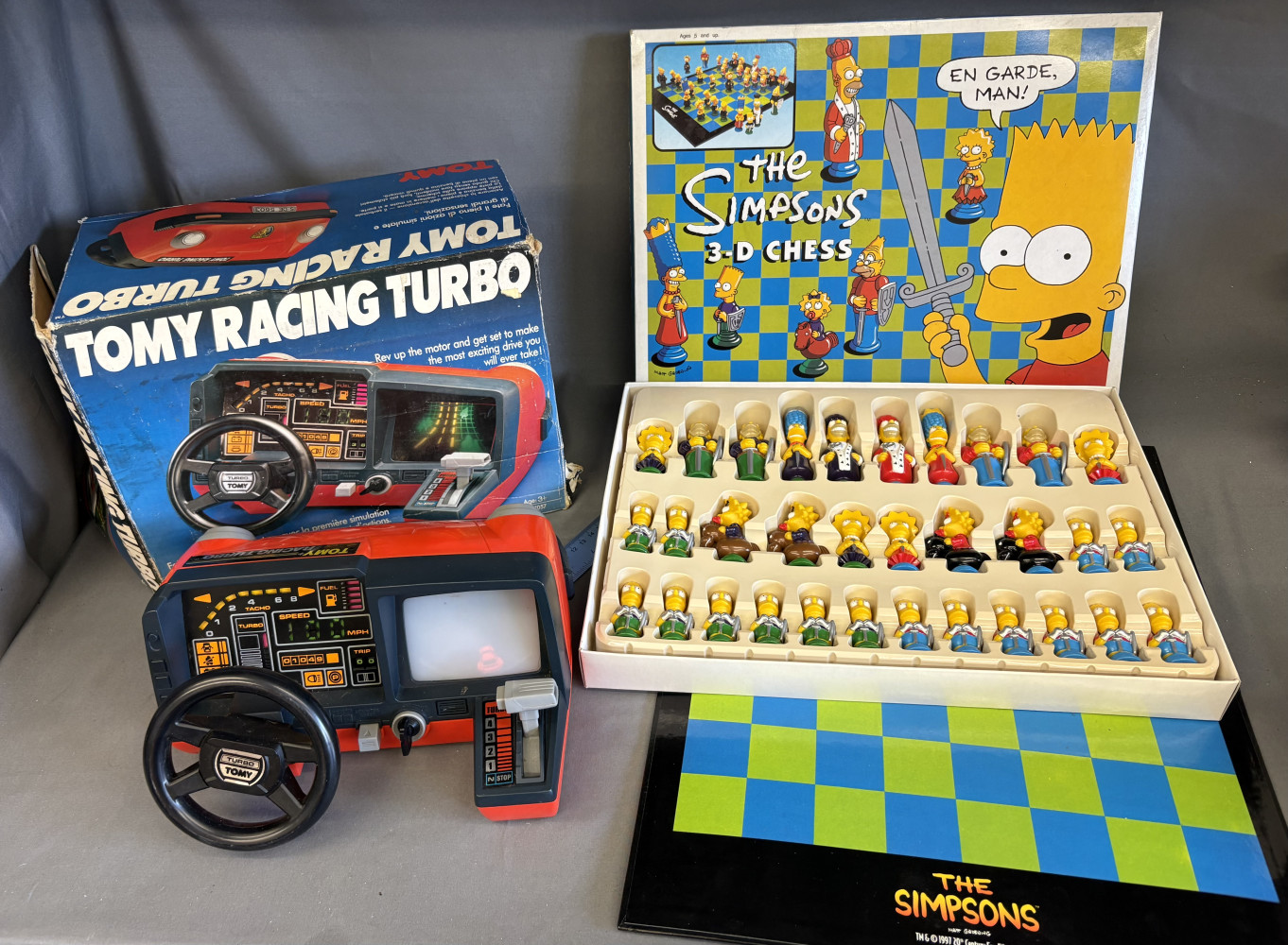 1980s boxed vintage Tomy Racing Turbo dashboard toy and Simpsons Chess set