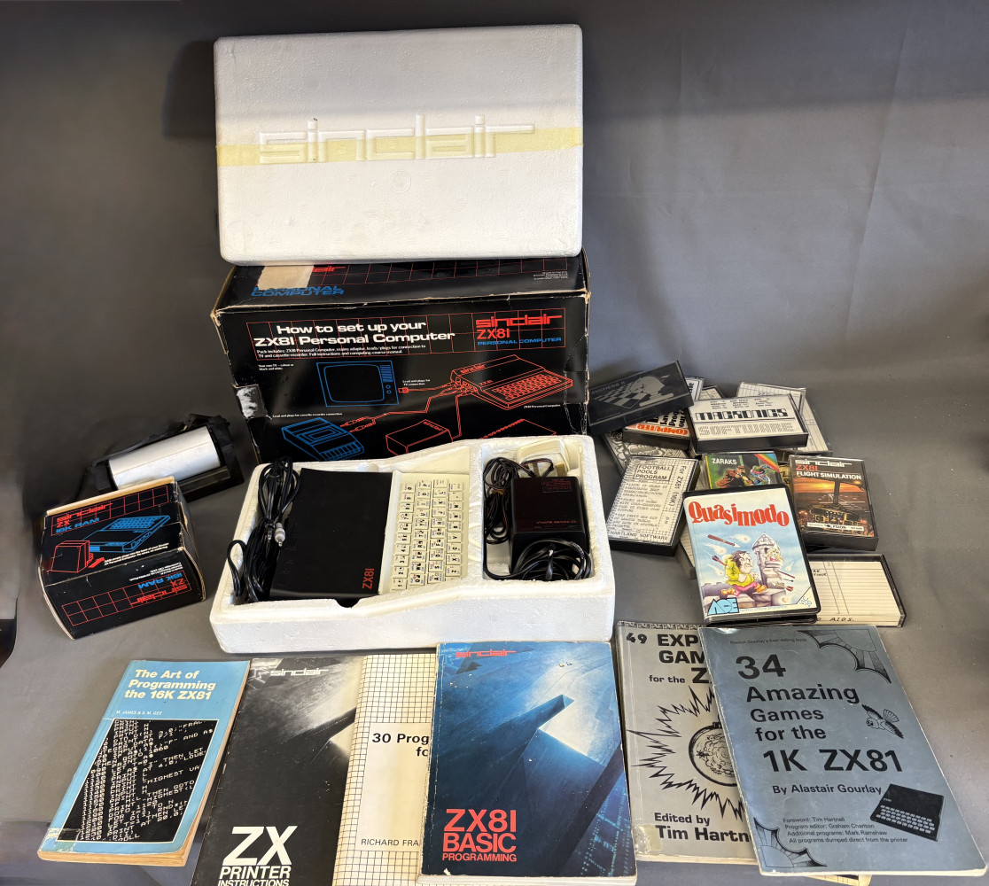 Vintage Sinclair ZX81 personal computer system in its original polystyrene packaging, complete with a keyboard unit, power supply, cables and other accessories