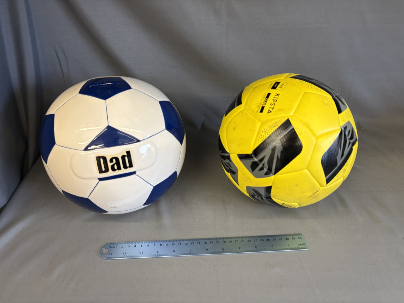 Large ceramic football shaped money box and yellow football