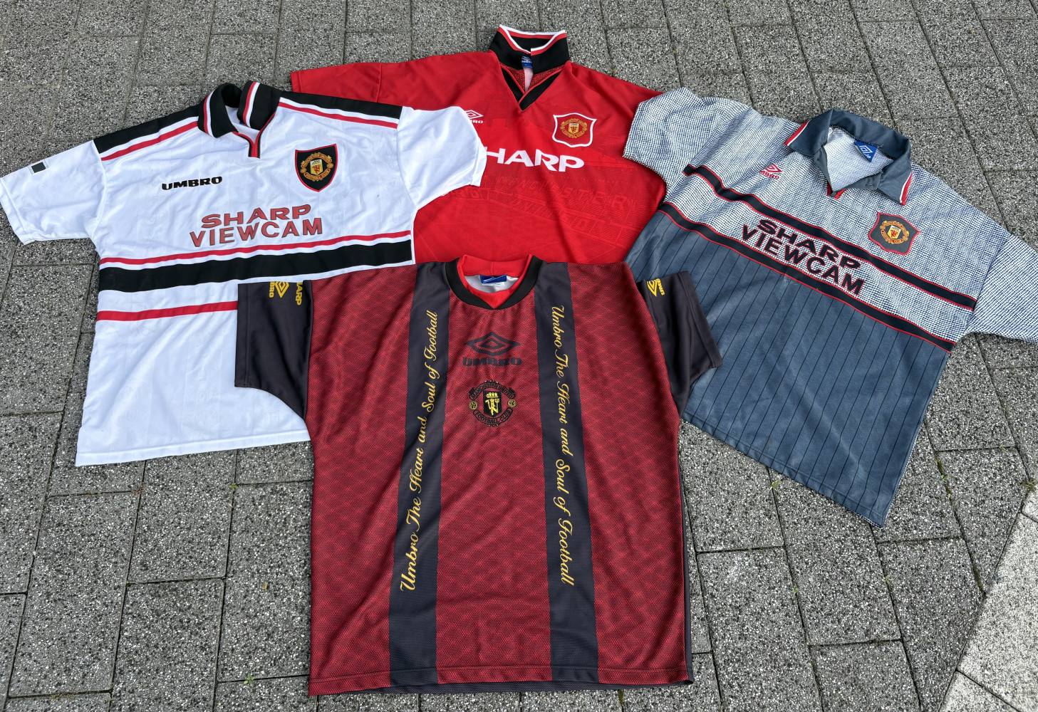 Collection of four classic vintage Umbro Manchester United football shirts from the 1990s