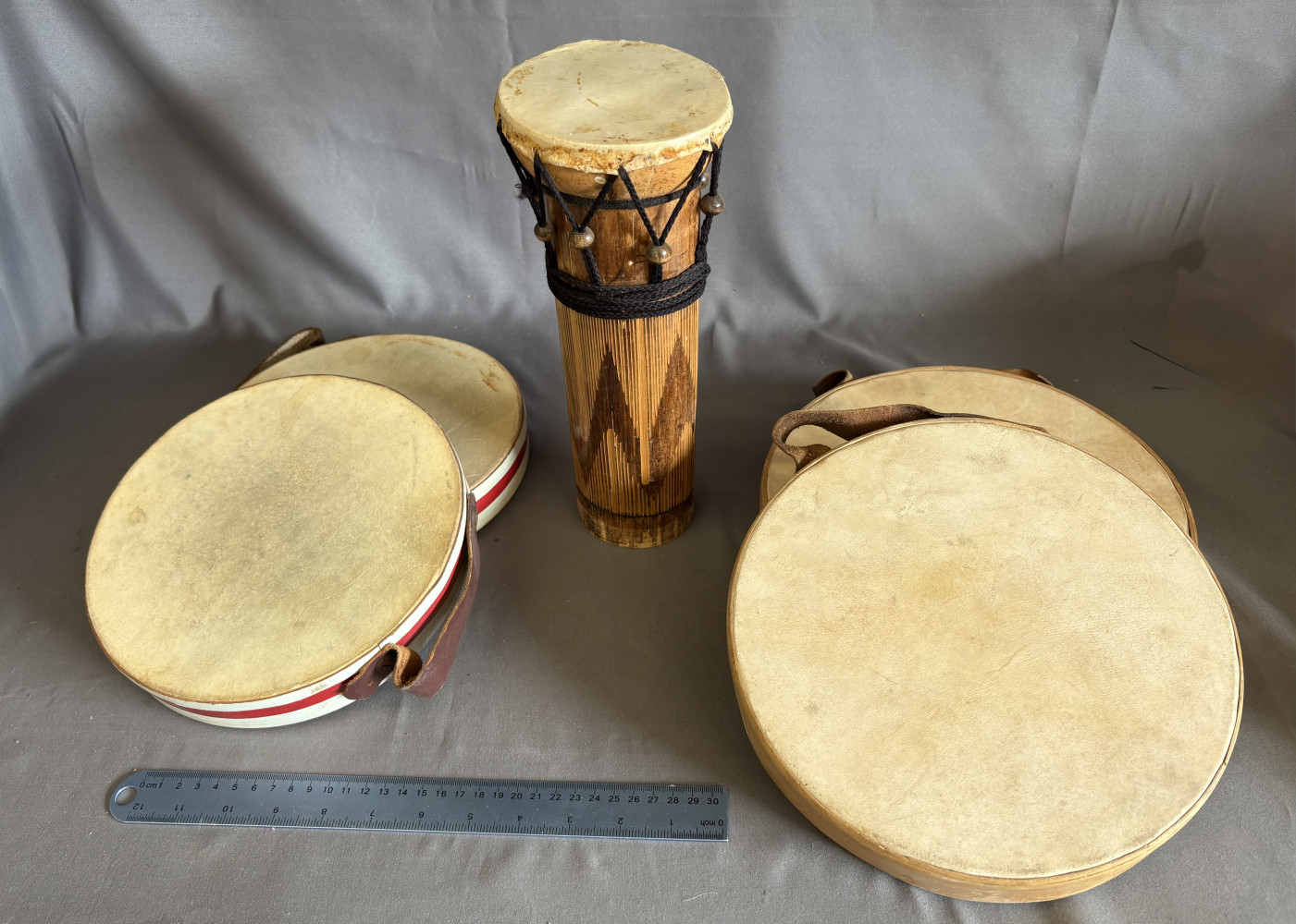 Traditional hand percussion instruments, including a tall carved wooden goblet drum 28cms tall and 2 pairs of hand drums