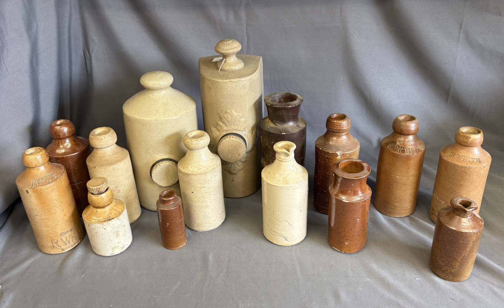 Collection of antique and vintage salt-glazed stoneware bottles, jugs, and inkwells