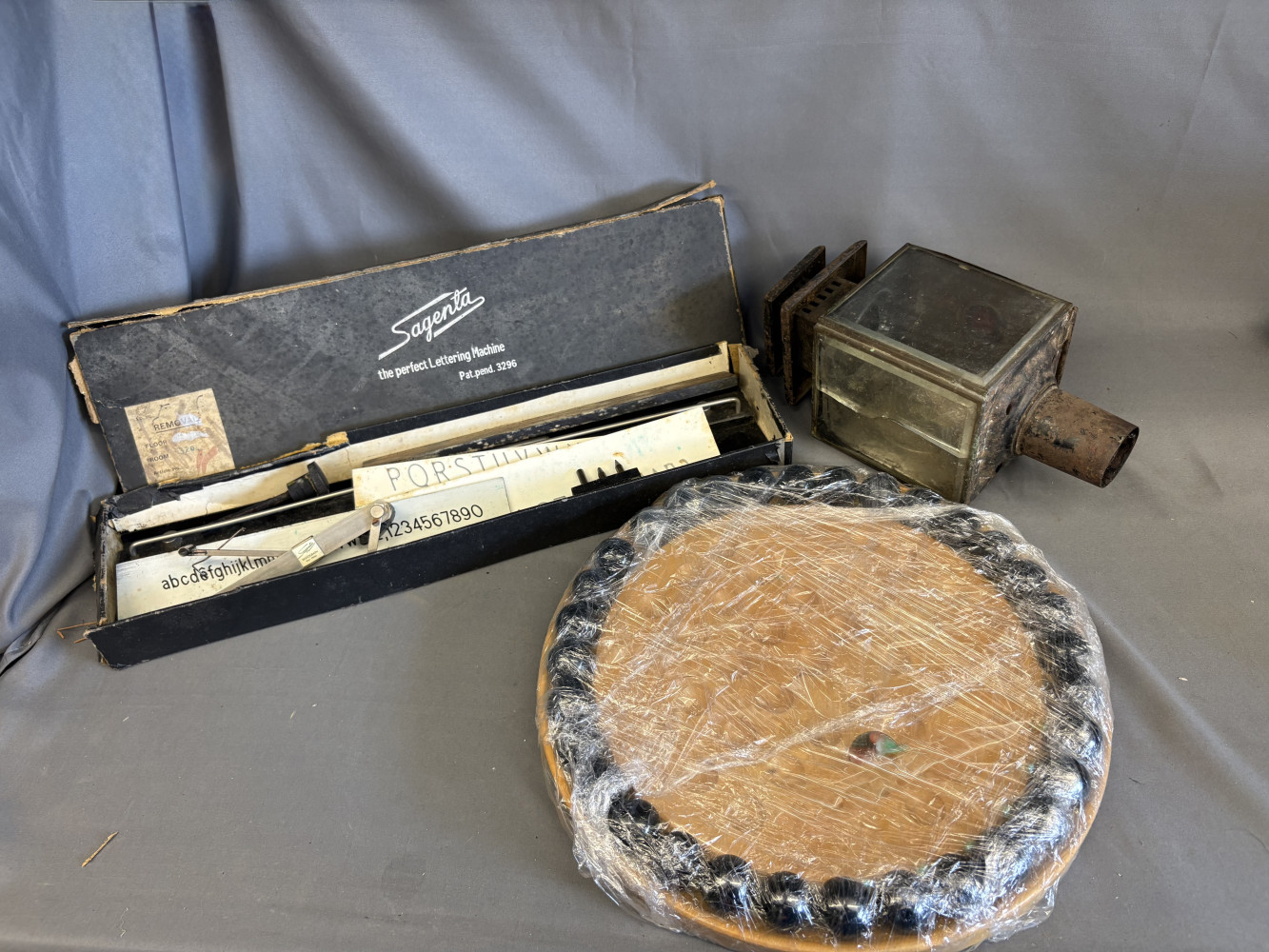 Antique carriage lamp; glass cracked on one side. A vintage Sagenta Lettering Machine and Solitaire board with marbles