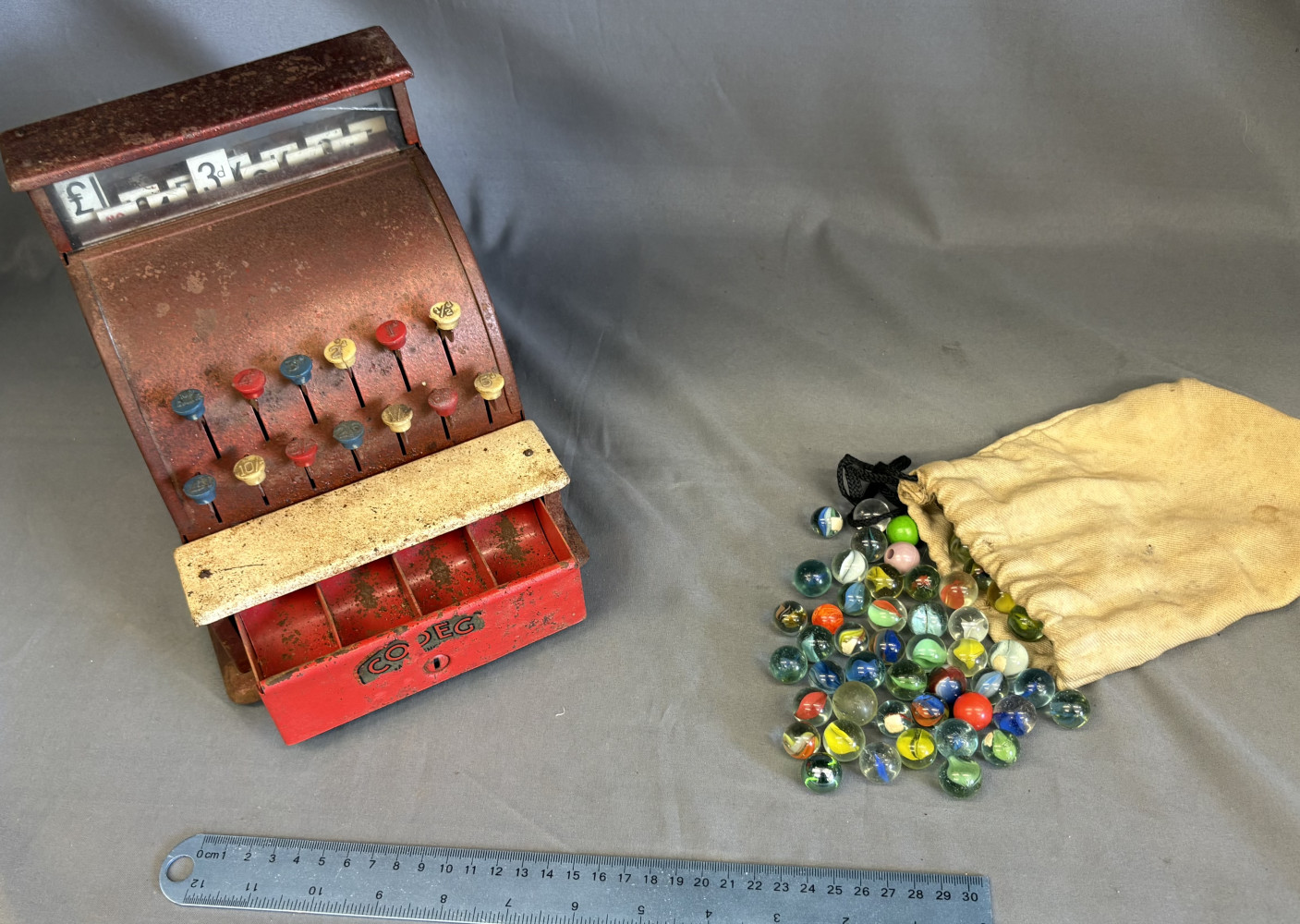 Bag of old marbles and a vintage 1950s CODEG Cash Register
