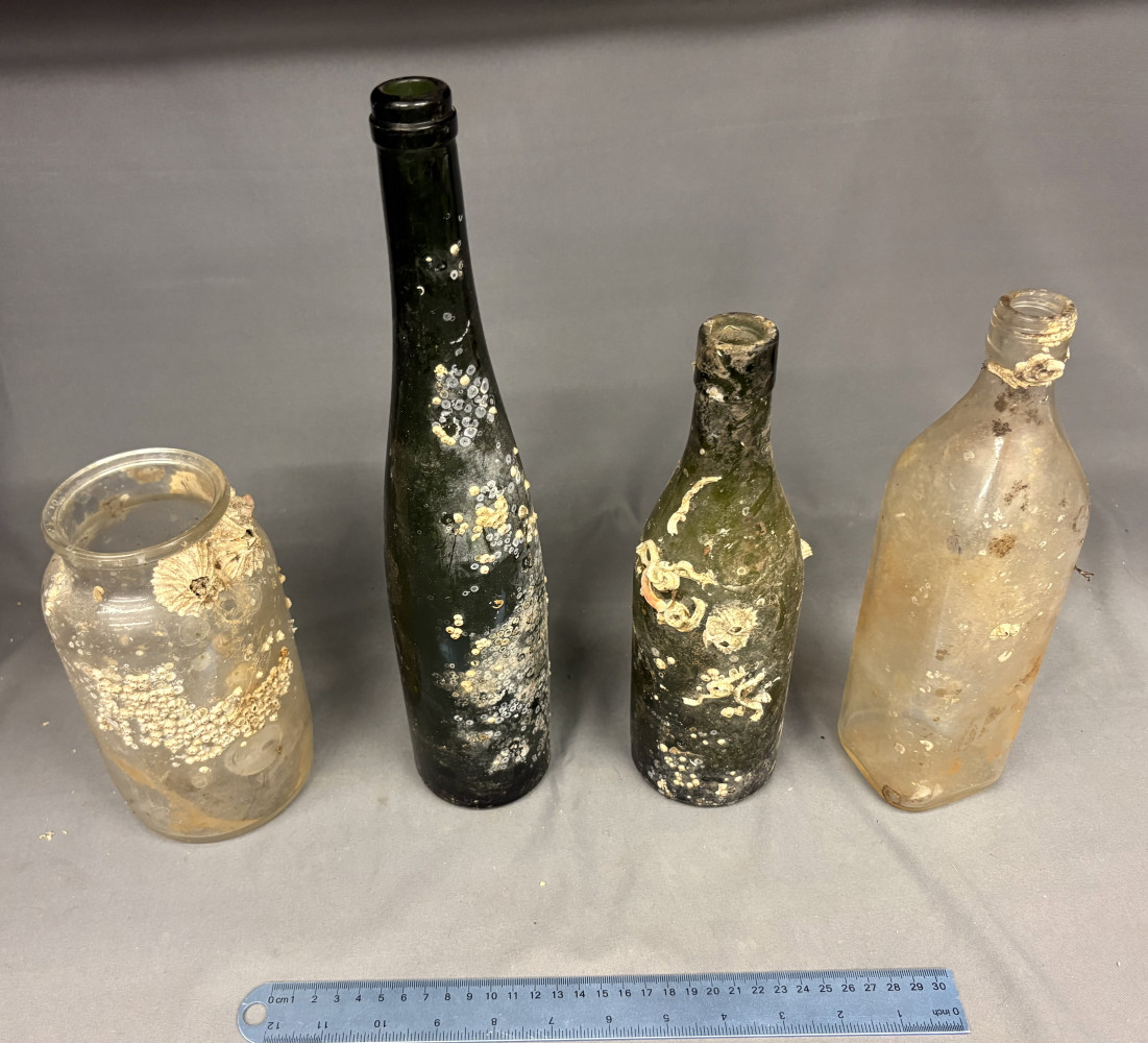 4 glass bottles pulled from a sea wreck
