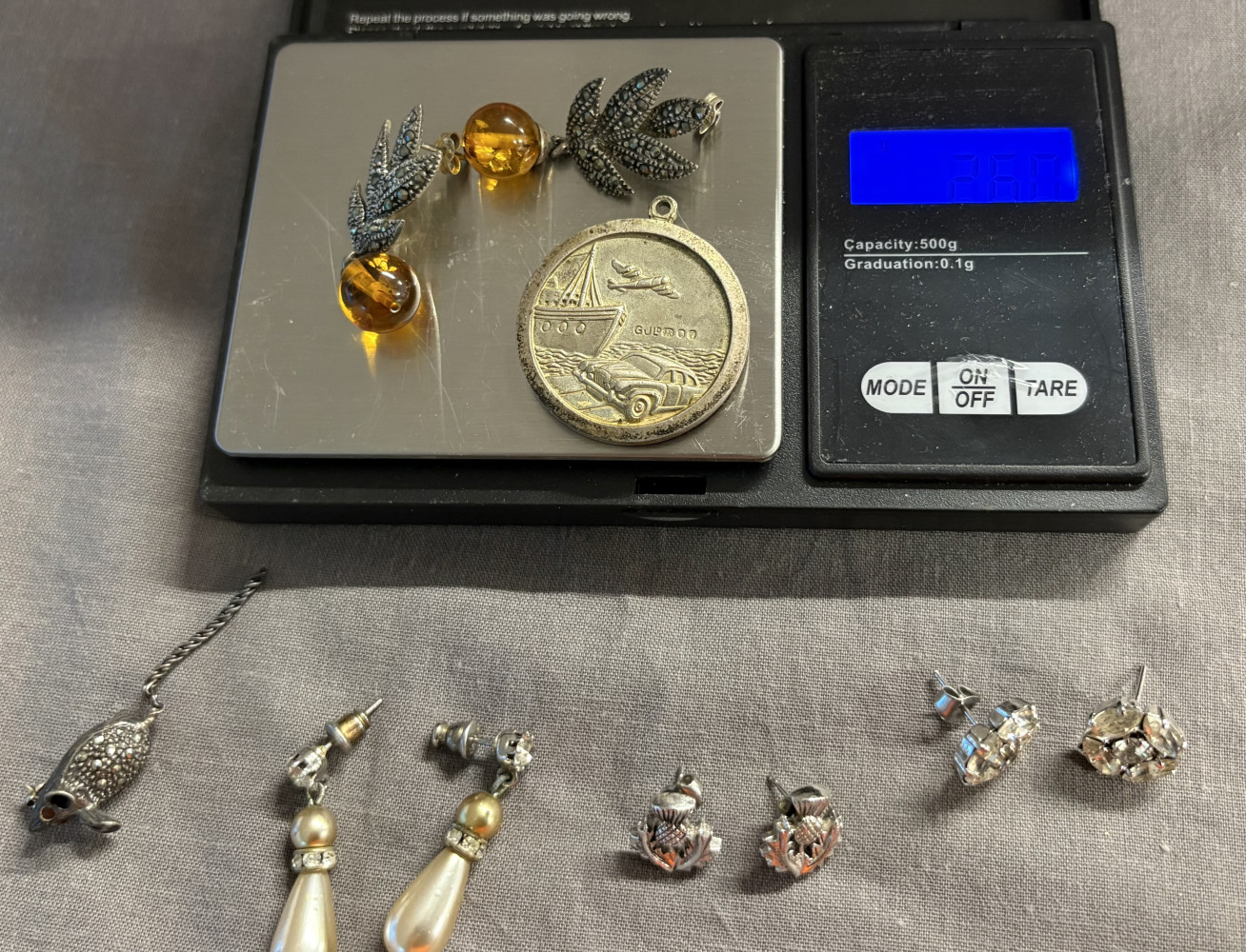 Silver earrings and pendant and other earrings