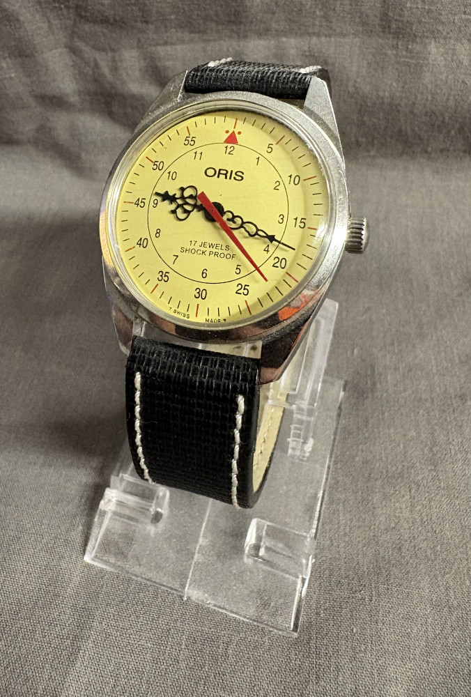 Oris men's manual-wind wristwatch with a yellow/mustard dial and a 17-jewel mechanical movement