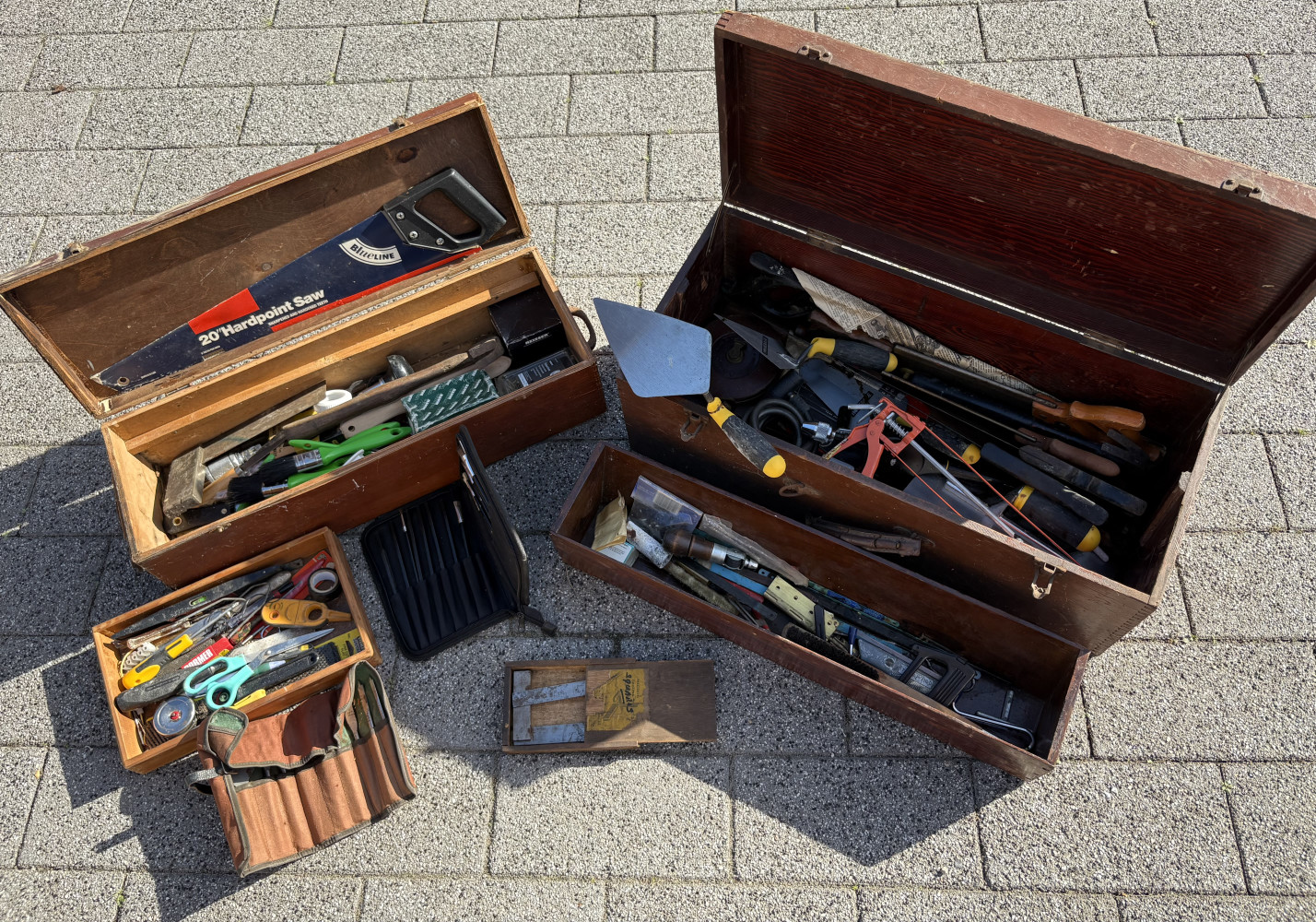 Two wooden tool boxes loaded with tools