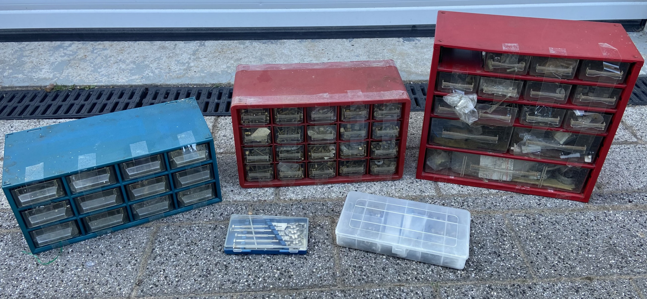 Three cases of fixings one full of brass and other tools