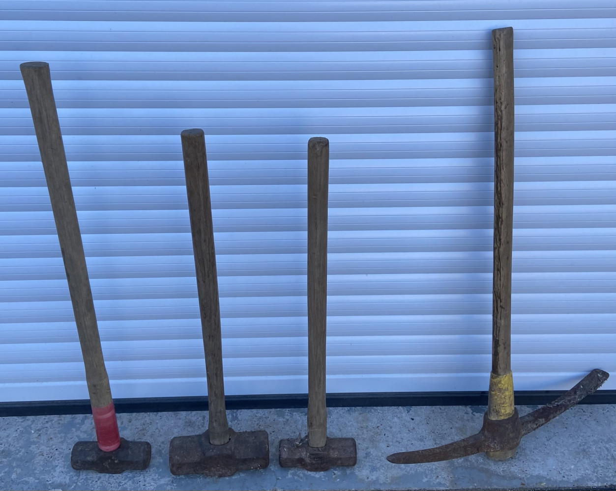 3 sledge hammers and pickaxe
