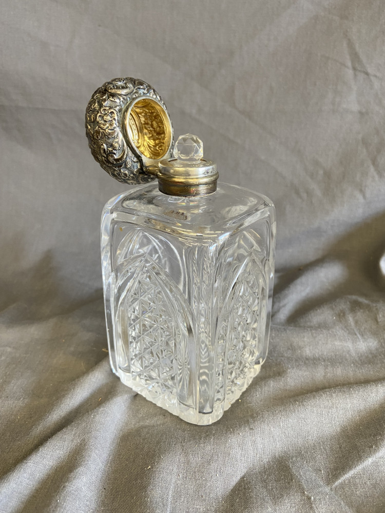 Silver topped glass bottle with stopper