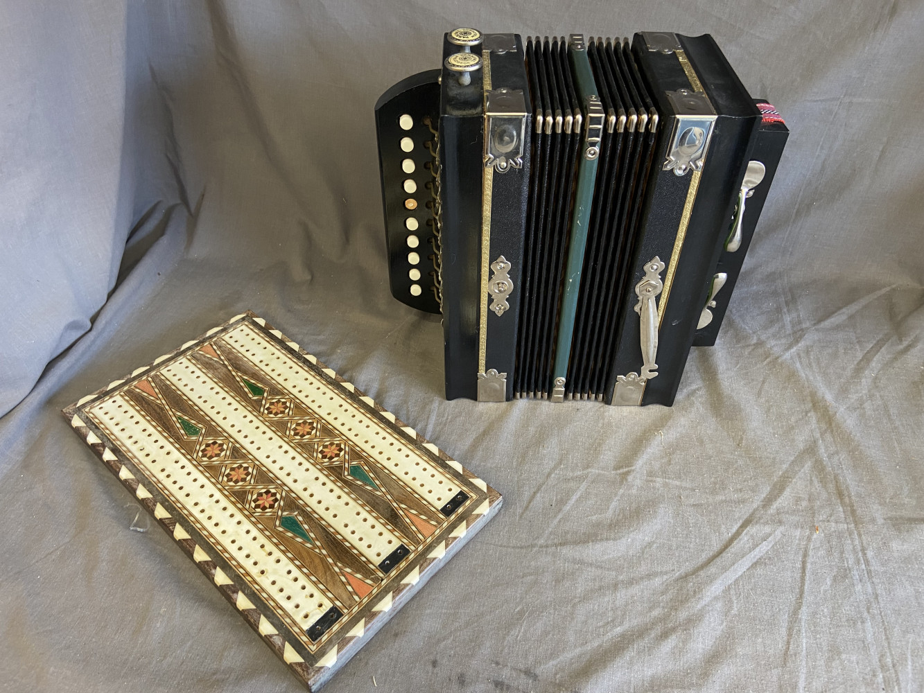 Accordion and cribbage board